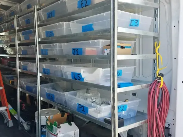 Labeled parts bins on the shelves of a service van